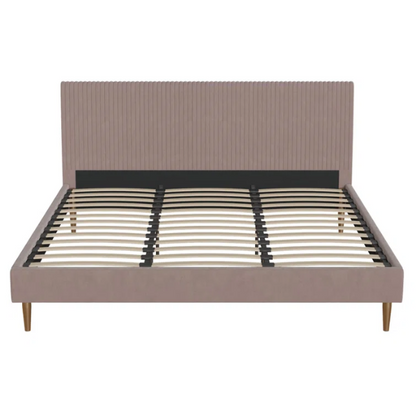 Blush pink velvet upholstered king-size platform bed with padded rectangular headboard, solid wood slats, and elegant low-profile frame.

