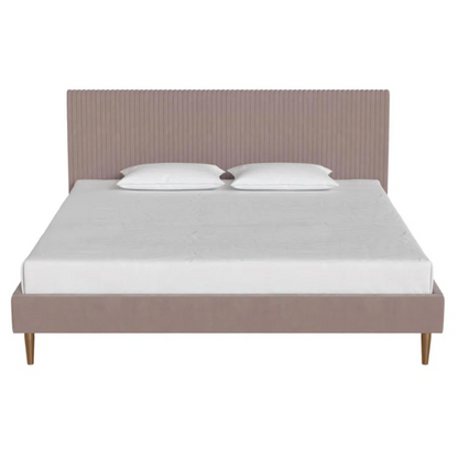 Blush pink velvet upholstered king-size platform bed with padded rectangular headboard, solid wood slats, and elegant low-profile frame.

