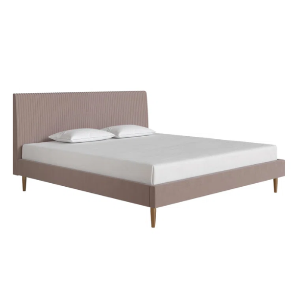 Blush pink velvet upholstered king-size platform bed with padded rectangular headboard, solid wood slats, and elegant low-profile frame.

