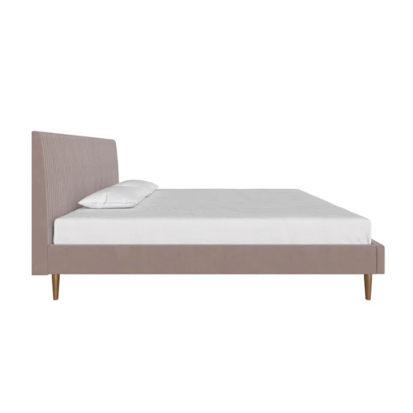 Blush pink velvet upholstered king-size platform bed with padded rectangular headboard, solid wood slats, and elegant low-profile frame.

