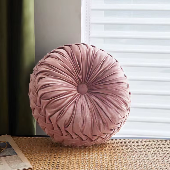 Blush velvet round throw pillow with ribbed edges and button detail, soft cotton fill for home décor