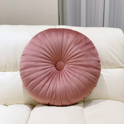 Blush velvet round throw pillow with button closure and pleated design, soft cotton fill for added comfort and support, perfect for home décor and sofa.