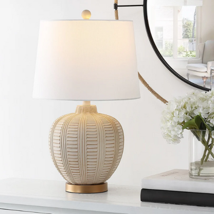 Cream and rose gold resin table lamp with carved textured base, white cotton drum shade, and built-in USB charging port for modern boho interiors

