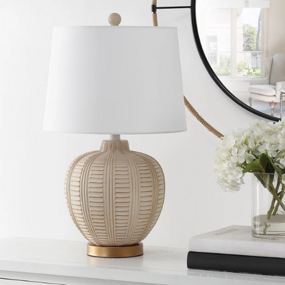 Cream and rose gold resin table lamp with carved textured base, white cotton drum shade, and built-in USB charging port for modern boho interiors

