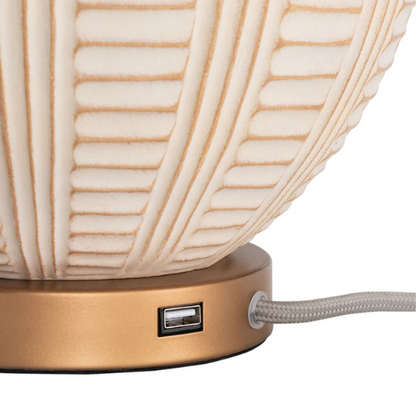 Cream and rose gold resin table lamp with carved textured base, white cotton drum shade, and built-in USB charging port for modern boho interiors

