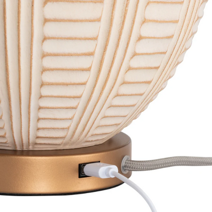 Cream and rose gold resin table lamp with carved textured base, white cotton drum shade, and built-in USB charging port for modern boho interiors

