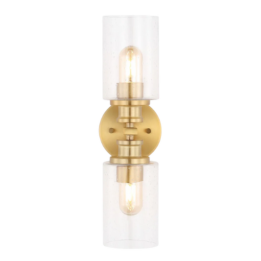 Rich brass wall sconce with dual clear seeded glass cylinder shades and Edison-style LED bulbs, perfect for upscale bathroom or hallway lighting

