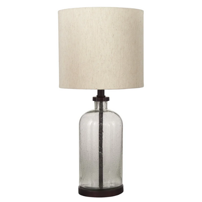 Bronze-tone seeded glass table lamp with beige fabric drum shade, featuring a metal base and compact design for modern farmhouse or industrial interiors

