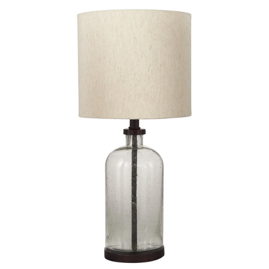 Bronze-tone seeded glass table lamp with beige fabric drum shade, featuring a metal base and compact design for modern farmhouse or industrial interiors


