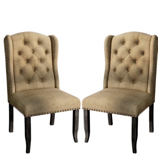 Set of two brown gold wingback dining chairs with tufted backs, nailhead trim, and espresso-finished legs, perfect for farmhouse or traditional dining spaces.