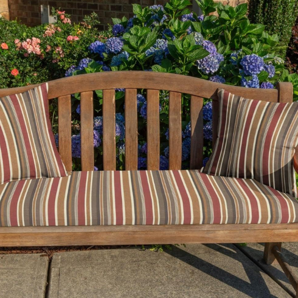 Striped accent pillow in brown, red, and beige – reversible, weather-resistant, and overstuffed with polyester fill for durable comfort indoors or outdoors.

