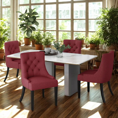 Set of four burgundy upholstered dining chairs featuring diamond tufted backs, armless design, sloped arms, and espresso brown wooden legs.

