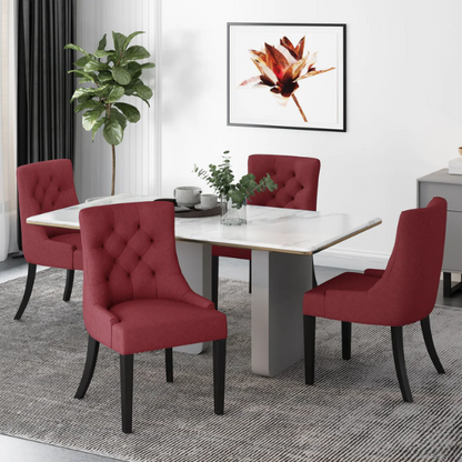 Set of four burgundy upholstered dining chairs featuring diamond tufted backs, armless design, sloped arms, and espresso brown wooden legs.

