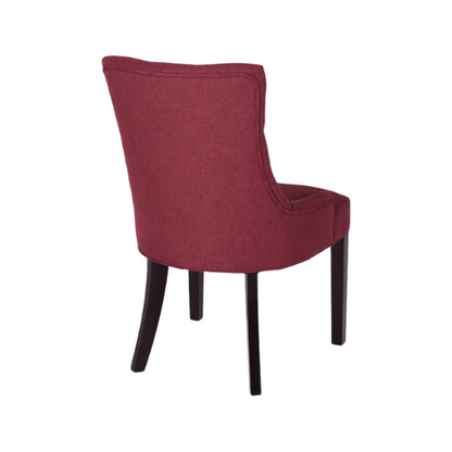 Set of four burgundy upholstered dining chairs featuring diamond tufted backs, armless design, sloped arms, and espresso brown wooden legs.

