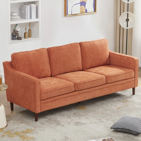 Burnt orange chenille upholstered sofa with curved track arms, brown tapered wooden legs, and plush foam cushions in a modern mid-century design.
