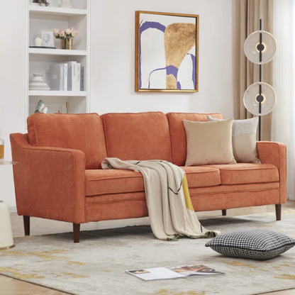 Burnt orange chenille upholstered sofa with curved track arms, brown tapered wooden legs, and plush foam cushions in a modern mid-century design.