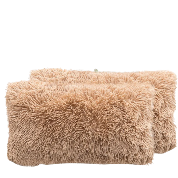 Set of two camel faux fur throw pillows with plush texture on a modern sofa

