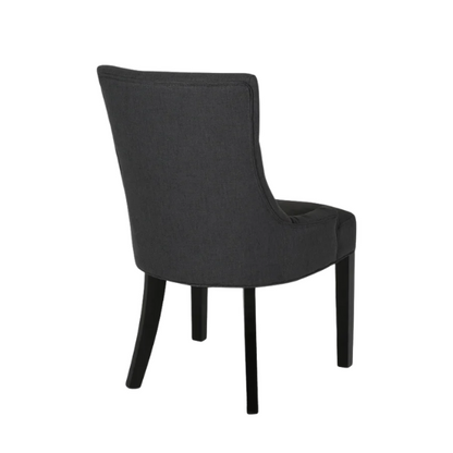 Set of four dark charcoal grey upholstered dining chairs featuring diamond tufted backs, armless design, sloped sides, and espresso wood legs.

