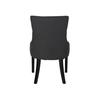 Set of four dark charcoal grey upholstered dining chairs featuring diamond tufted backs, armless design, sloped sides, and espresso wood legs.

