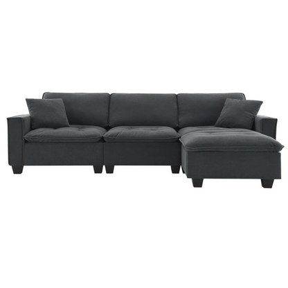 Charcoal grey suede L-shaped sectional sofa with tufted cushions, reversible chaise, removable ottoman, and two matching throw pillows