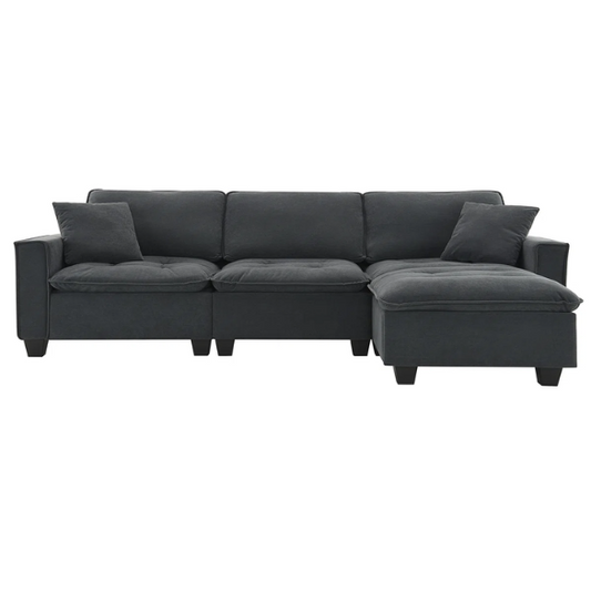 Charcoal grey suede L-shaped sectional sofa with tufted cushions, reversible chaise, removable ottoman, and two matching throw pillows