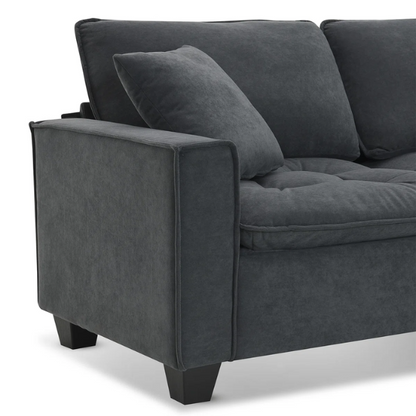 Charcoal grey suede L-shaped sectional sofa with tufted cushions, reversible chaise, removable ottoman, and two matching throw pillows