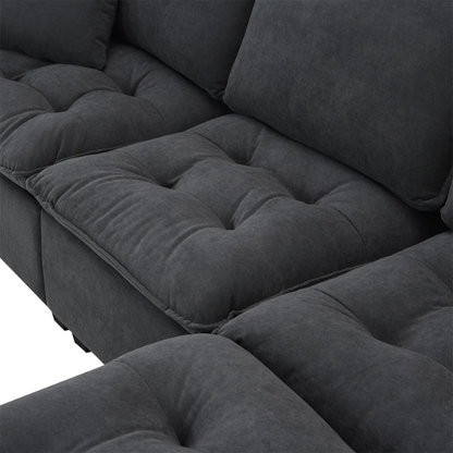 Charcoal grey suede L-shaped sectional sofa with tufted cushions, reversible chaise, removable ottoman, and two matching throw pillows