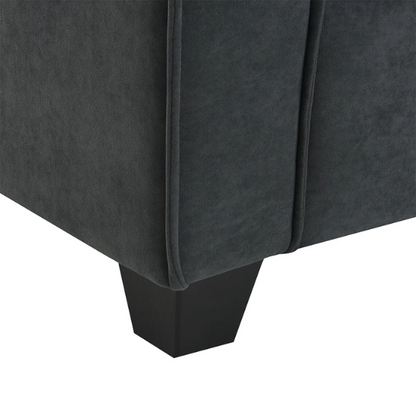 Charcoal grey suede L-shaped sectional sofa with tufted cushions, reversible chaise, removable ottoman, and two matching throw pillows