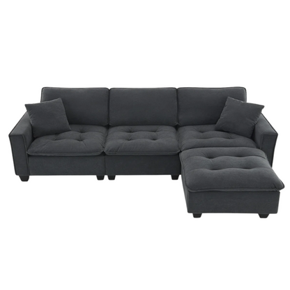 Charcoal grey suede L-shaped sectional sofa with tufted cushions, reversible chaise, removable ottoman, and two matching throw pillows