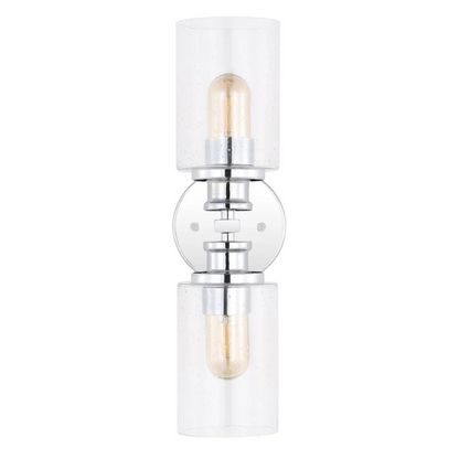 Polished chrome wall sconce with dual clear seeded glass cylinder shades and Edison-style LED bulbs, ideal for modern bathrooms or entryways

