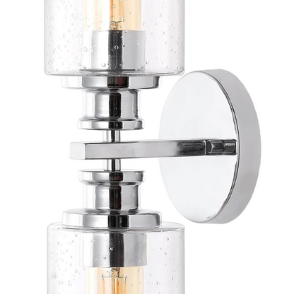 Polished chrome wall sconce with dual clear seeded glass cylinder shades and Edison-style LED bulbs, ideal for modern bathrooms or entryways


