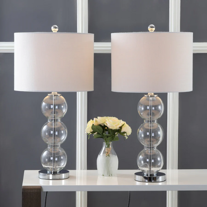Set of 2 clear glass table lamps with triple-sphere design, polished silver accents, and white linen drum shades – elegant lighting for bedroom, living room, or office

