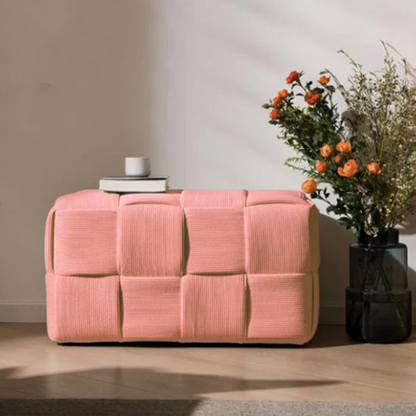 Blush velvet ottoman with modern cube design and durable wood frame.