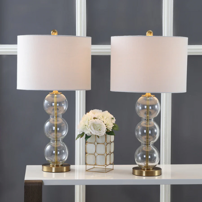 Set of 2 contemporary table lamps with clear glass triple-sphere base, gold accents, and white linen drum shade – modern glam bedside or living room lighting

