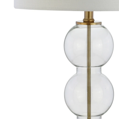 Set of 2 contemporary table lamps with clear glass triple-sphere base, gold accents, and white linen drum shade – modern glam bedside or living room lighting

