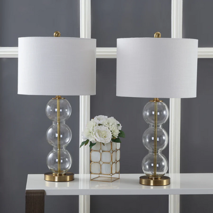Set of 2 contemporary table lamps with clear glass triple-sphere base, gold accents, and white linen drum shade – modern glam bedside or living room lighting

