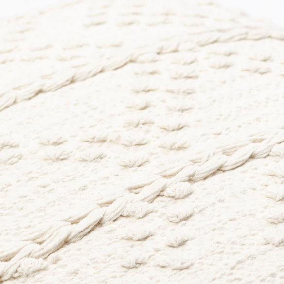 Cream handwoven boho throw pillow with chevron texture on a modern neutral-toned sofa

