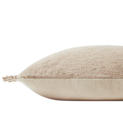 Cream cotton blend throw pillow with fringe, 22x22 square cushion, styled on a modern sofa for soft, neutral home decor.

