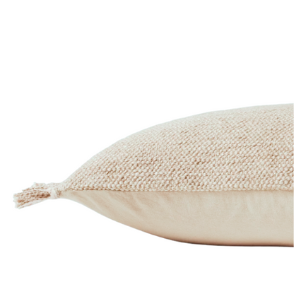 Cream lumbar throw pillow with soft fringe trim, rectangular 13x21 design, made from neutral cotton blend fabric, styled on a sofa for cozy, modern home decor.

