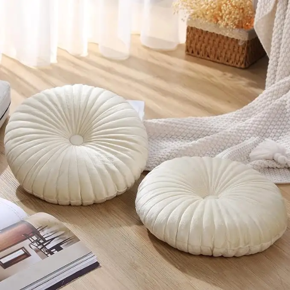 Elegant cream velvet round throw pillow with button detail for home décor