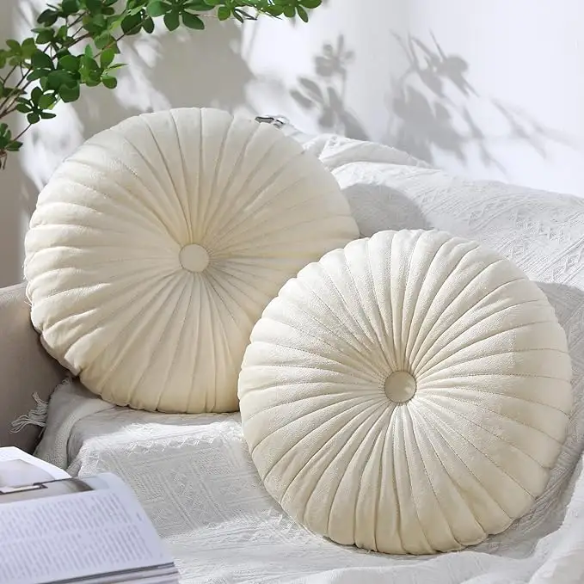 Elegant cream velvet round throw pillow with button detail for home décor