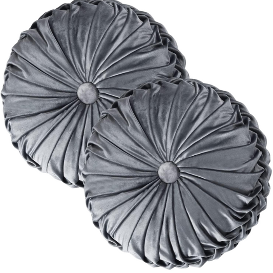 Dark grey velvet round throw pillows with hand-pleated design and button center, set of two 14.5-inch plush cushions styled in a modern living space.


