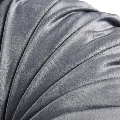 Dark grey velvet round throw pillows with hand-pleated design and button center, set of two 14.5-inch plush cushions styled in a modern living space.

