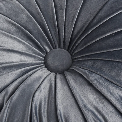 Dark grey velvet round throw pillows with hand-pleated design and button center, set of two 14.5-inch plush cushions styled in a modern living space.

