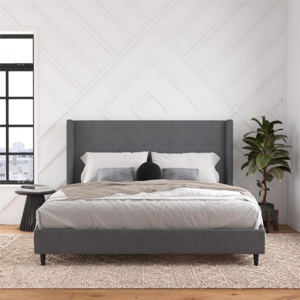 Dark grey soft woven upholstered king platform bed with tall wingback headboard and sturdy slat support.

