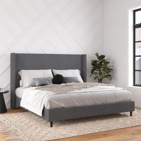 Dark grey soft woven upholstered king platform bed with tall wingback headboard and sturdy slat support.


