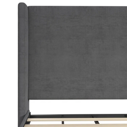 Dark grey soft woven upholstered king platform bed with tall wingback headboard and sturdy slat support.

