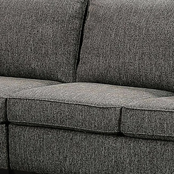 Dark grey transitional L-shaped sectional sofa with rolled arms, welt-trimmed cushions, and checkerboard accent pillows
