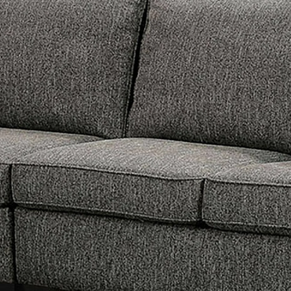 Dark grey transitional L-shaped sectional sofa with rolled arms, welt-trimmed cushions, and checkerboard accent pillows