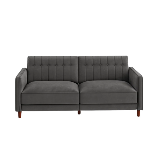 Dark grey velvet convertible sofa with vertical tufting, split-back design, square arms, and brown tapered legs, convertible into a twin-size sleeper.